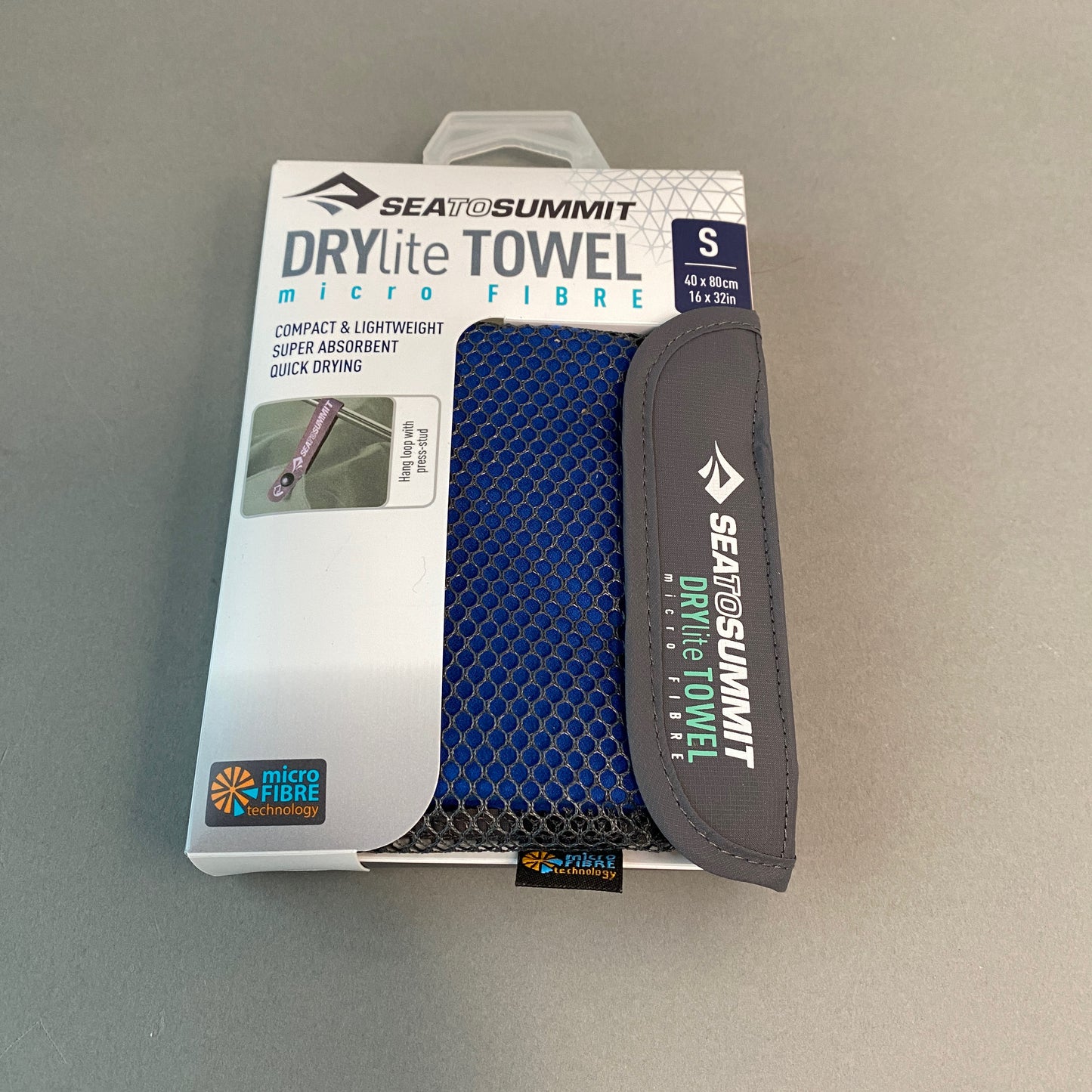 Photo of Drylite Towel from Sea to Summit.  Small blue micro fiber towel in a ventilated pouch