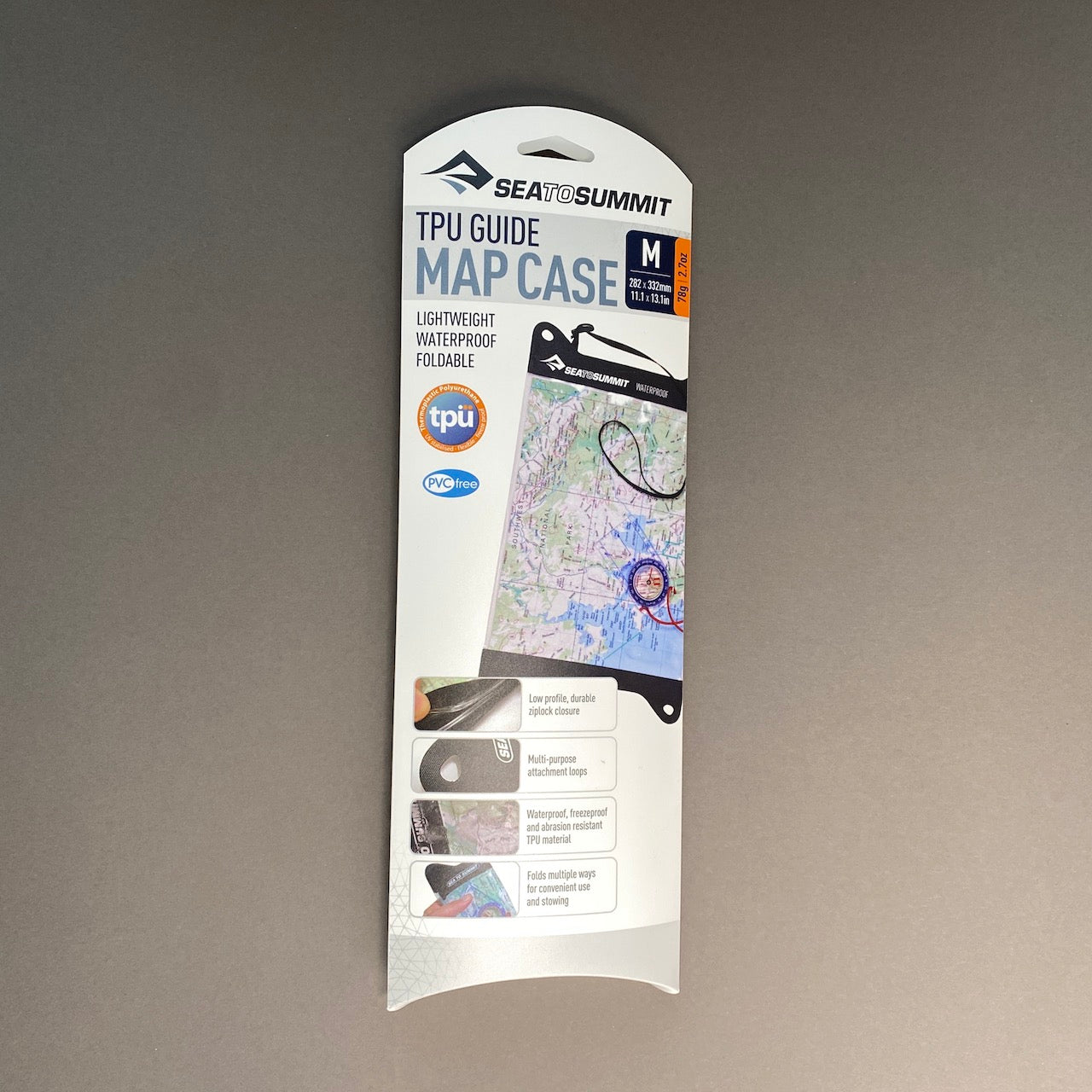 Photograph of TPU Map Case in its packaging.  Package is white rectangle with photo of map case and detail photos.  