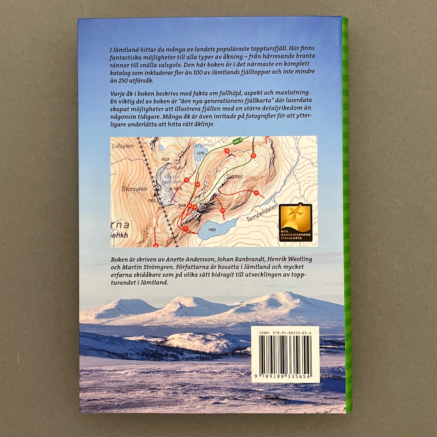 A blue colored back of a book with a picture of three mountains, a map and a summary of the same book laying on a gray background