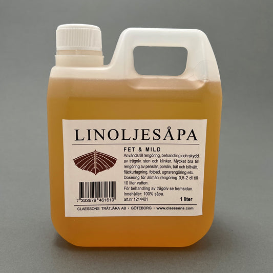 A 1 liter plastic container filled with linseed oil soap standing on a gray background