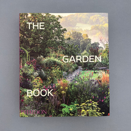 A book called "The Garden Book" with a picture of a flower garden as the cover