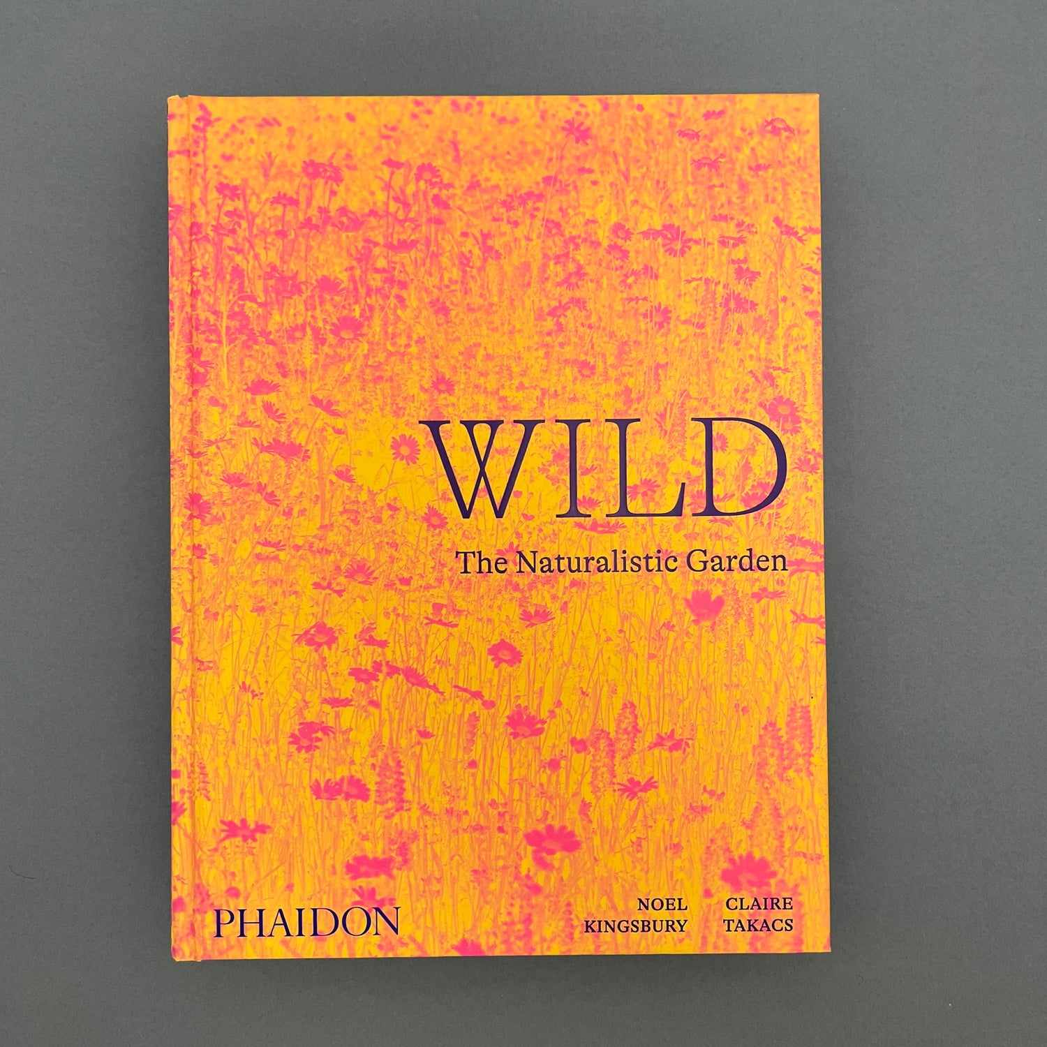 A book called "Wild The Naturalistic garden" with a yellow and pink flower field as the cover