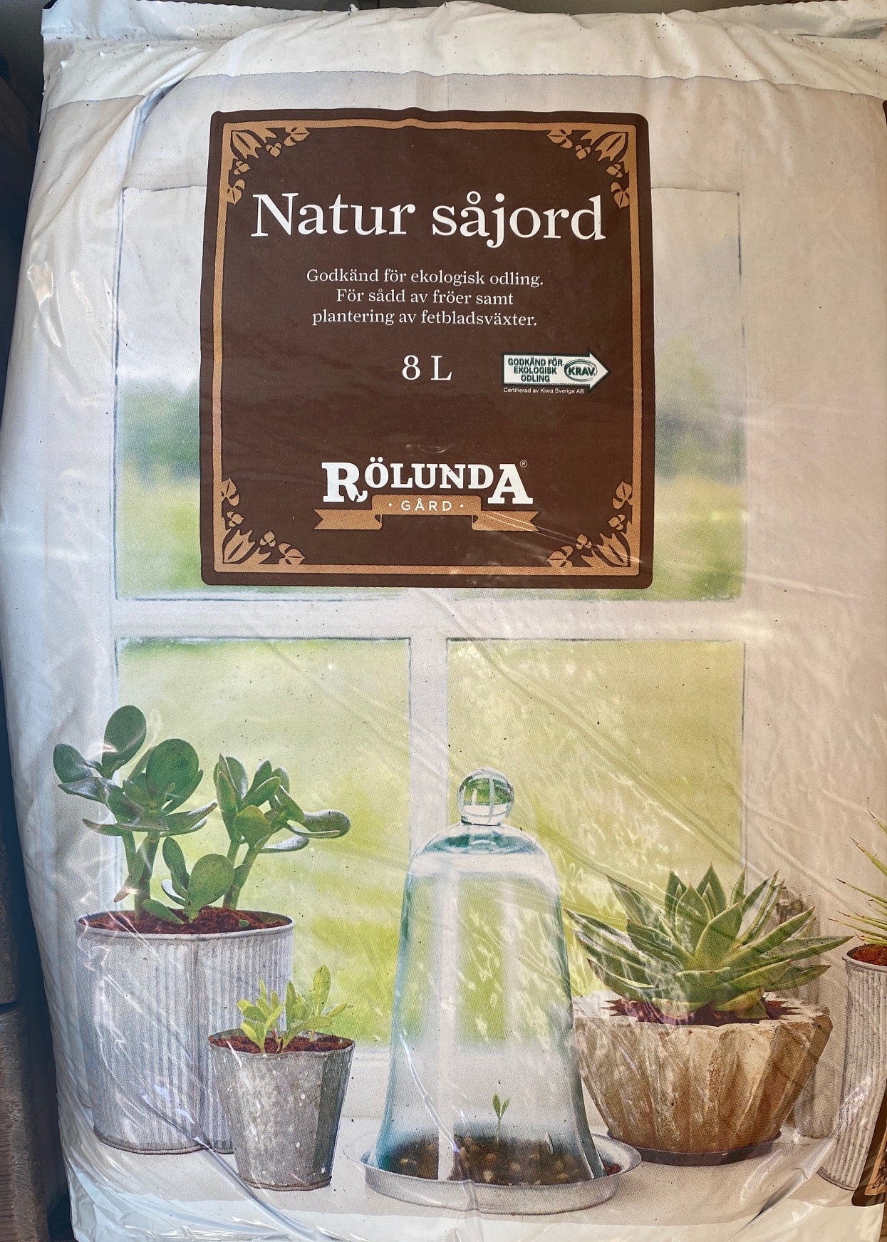 A white 8 liter bag of planting soil from Rölunda